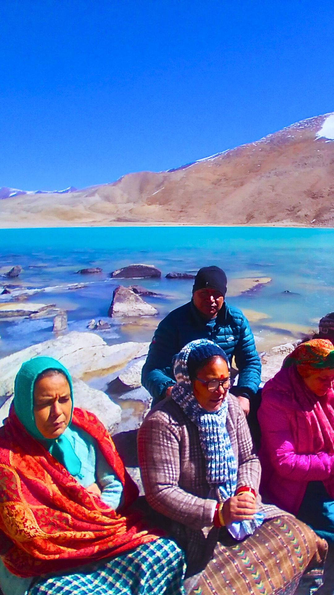 At the sacred lake devtaal with mana taal in the backdrop